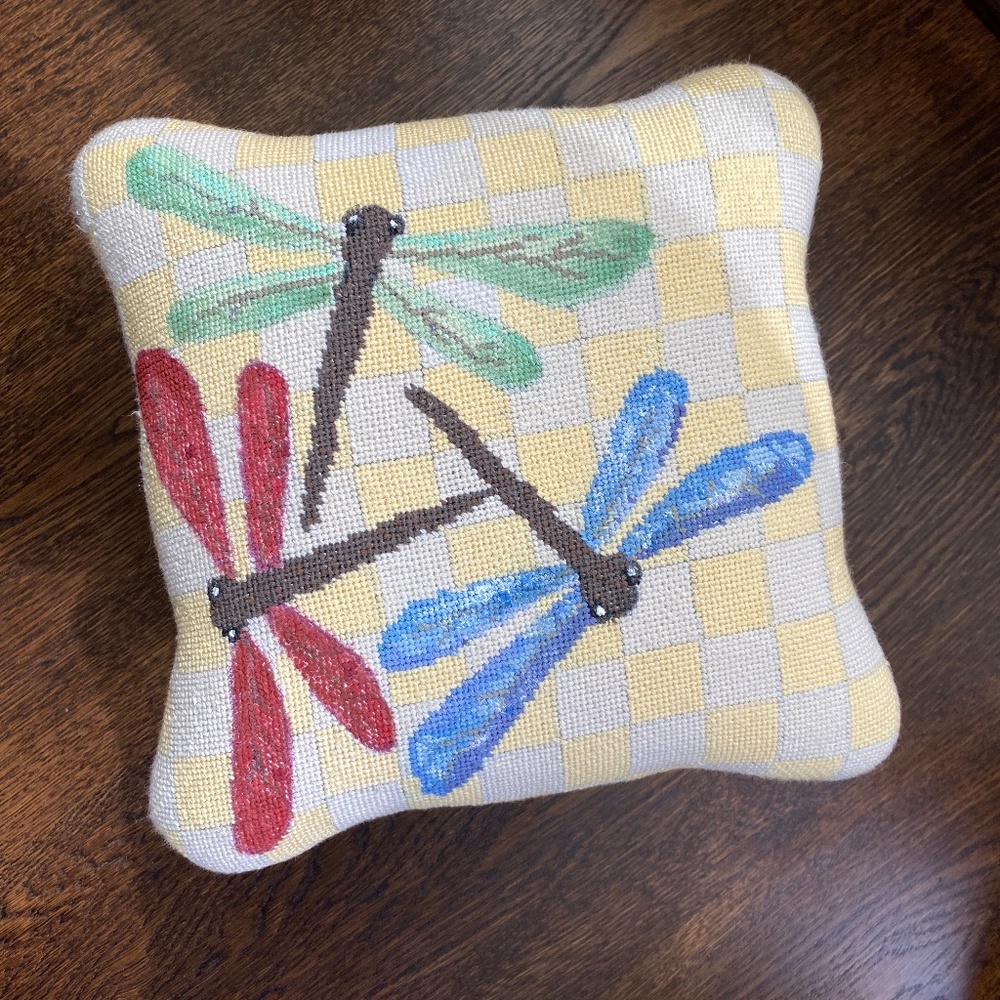 Carved iron footstool with custom needlepoint cover